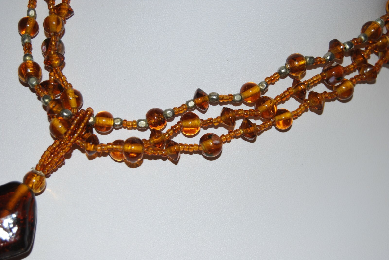 MULTI STRAND AMBER COLOR GLASS WITH LARGE GRIPOIX PENDANT STATEMENT NECKLACE