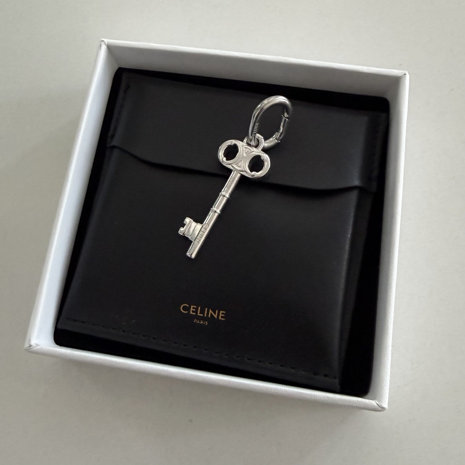 CELINE CHARM TRIOMPHE KEY IN BRASS WITH RHODIUM FINISH
