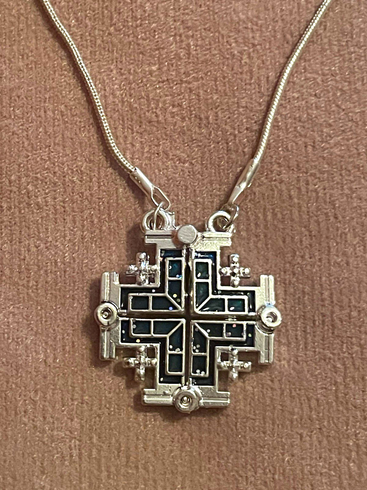 Sterling silver Jerusalem cross on 20” chain. Unfolds for a different look.