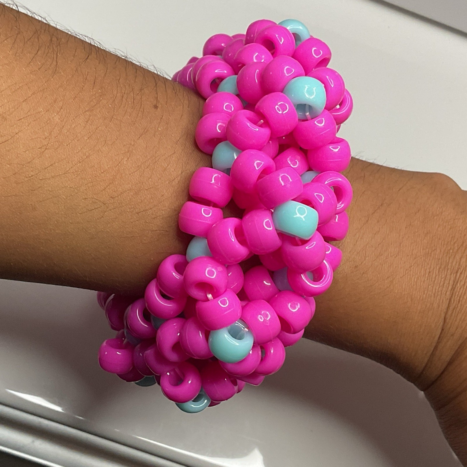handmade pink w/ cyan accents 3d X’s kandi cuff 😋😋😋 has SUPER stretchy string