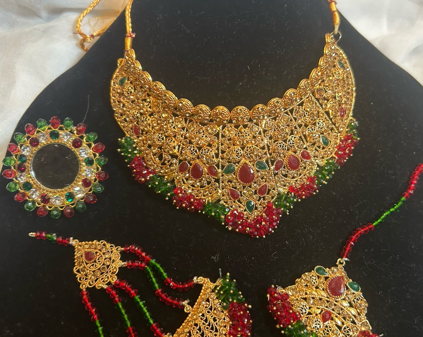 Gold Jewelry Set with Red and Green Details