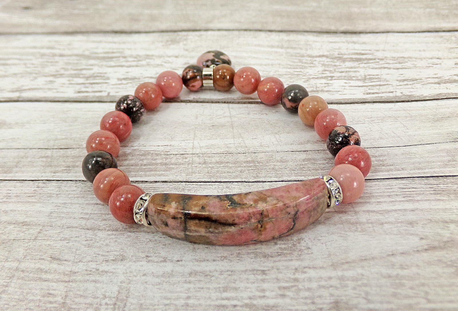 Pink heart charm bracelet made in rhodonite stone beads and crystal spacer beads
