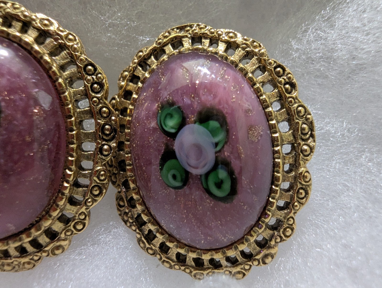 Gold Colored Filigree Earrings With Flower And Leaves Surrounded By Purple