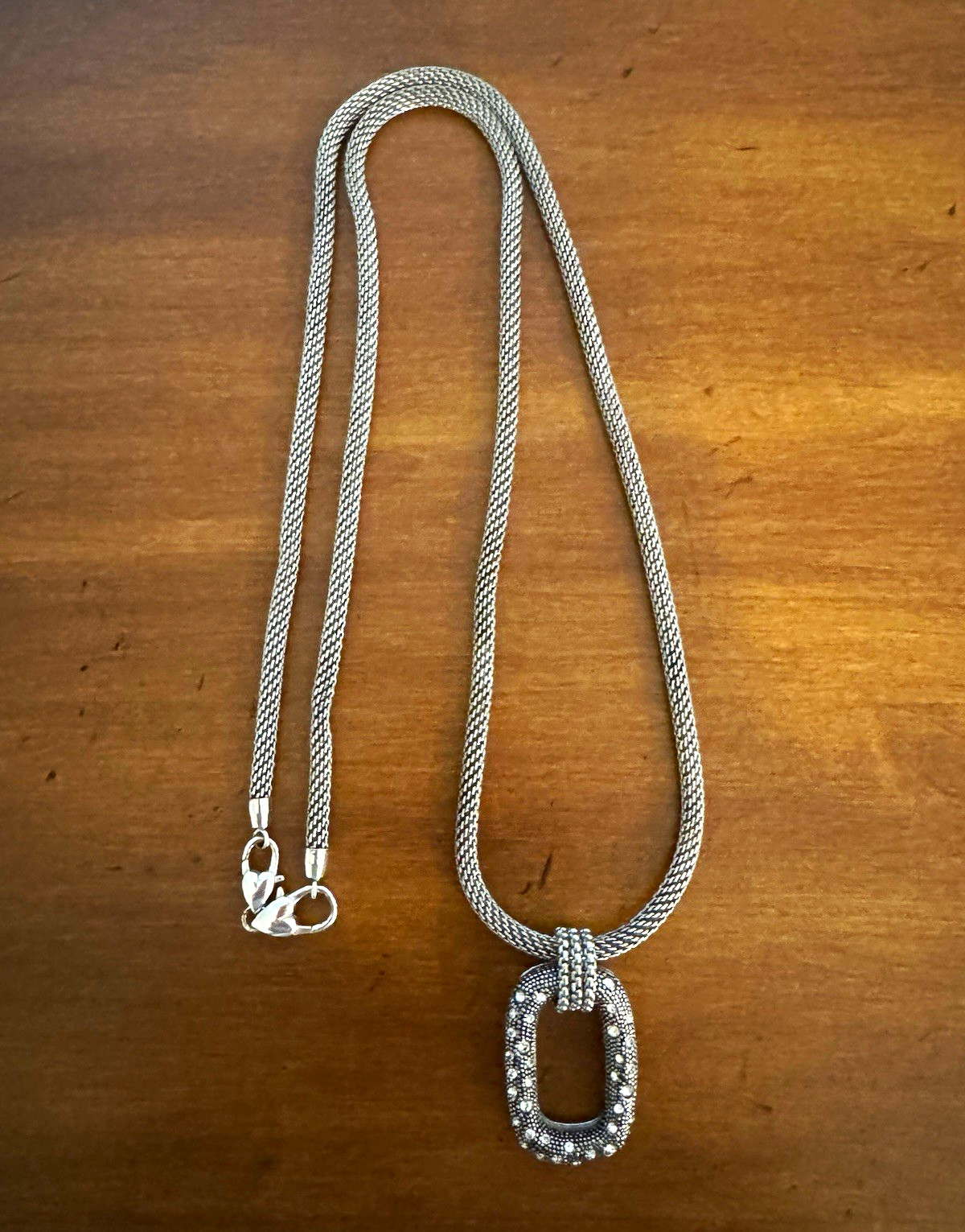 Elegant gunmetal chain with crystal-accented oval pendant