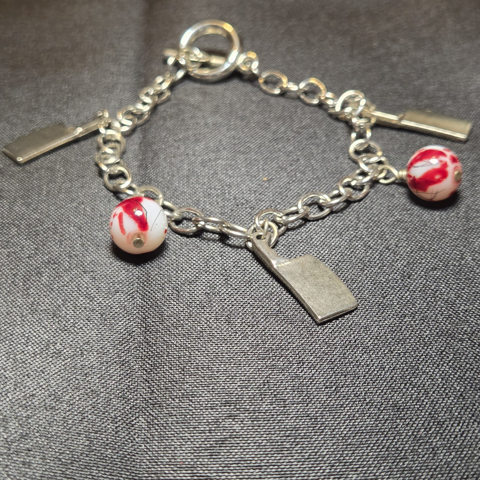 Silver-tone Charm Bracelet With Red Marbled Beads, Bold And Elegant For Any Wear