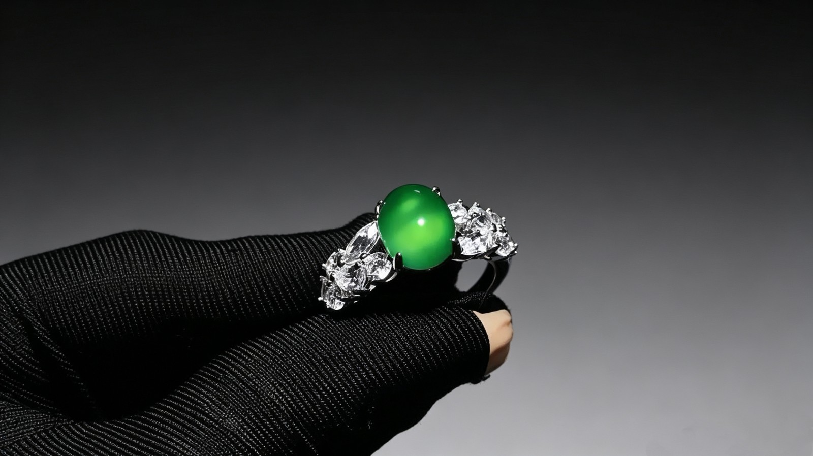 Oval emerald jadeite ring, side-set with zircons, adjustable opening