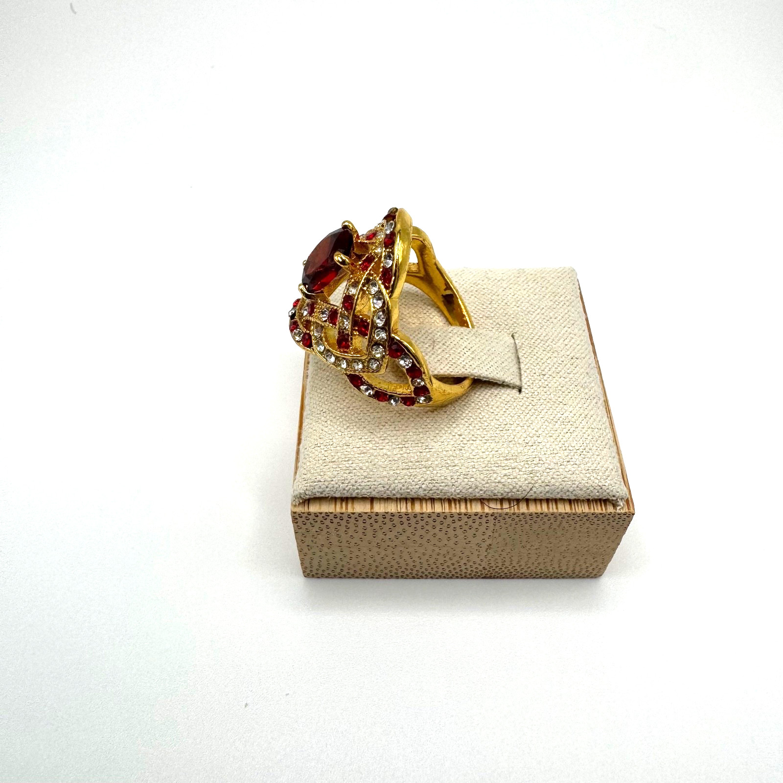 Gold tone statement ring bundle with one central stone and ornate accent stones