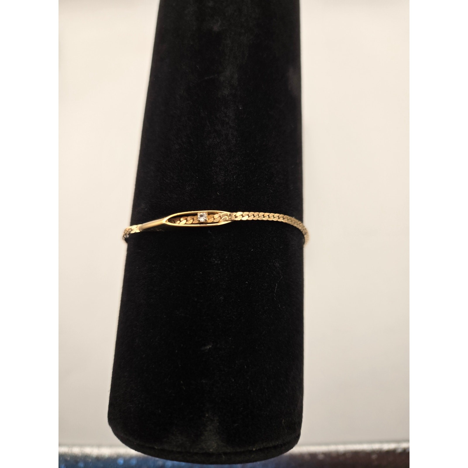 Avon Gold Tone Chain Bracelet with Single Rhinestone Plate.