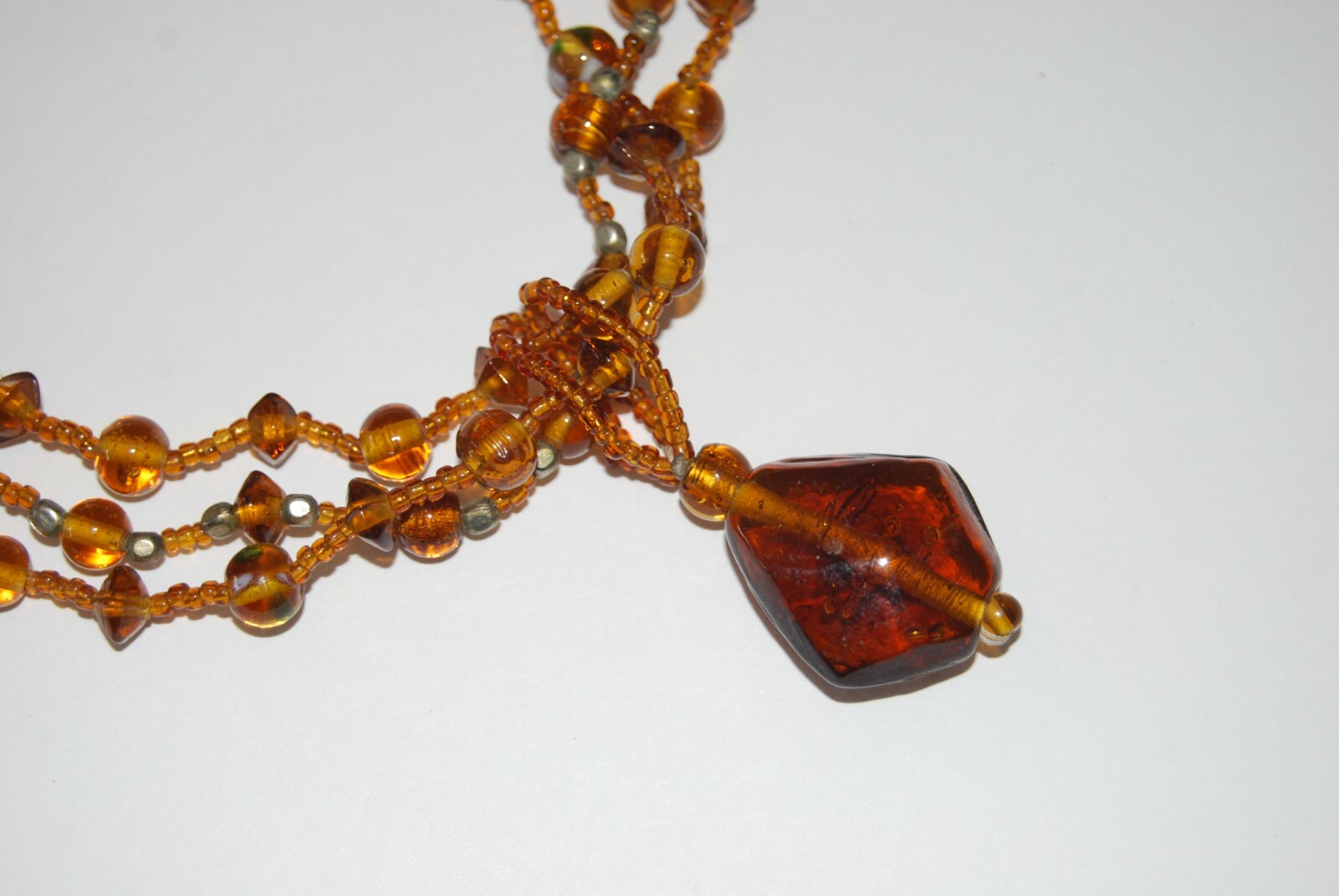 MULTI STRAND AMBER COLOR GLASS WITH LARGE GRIPOIX PENDANT STATEMENT NECKLACE