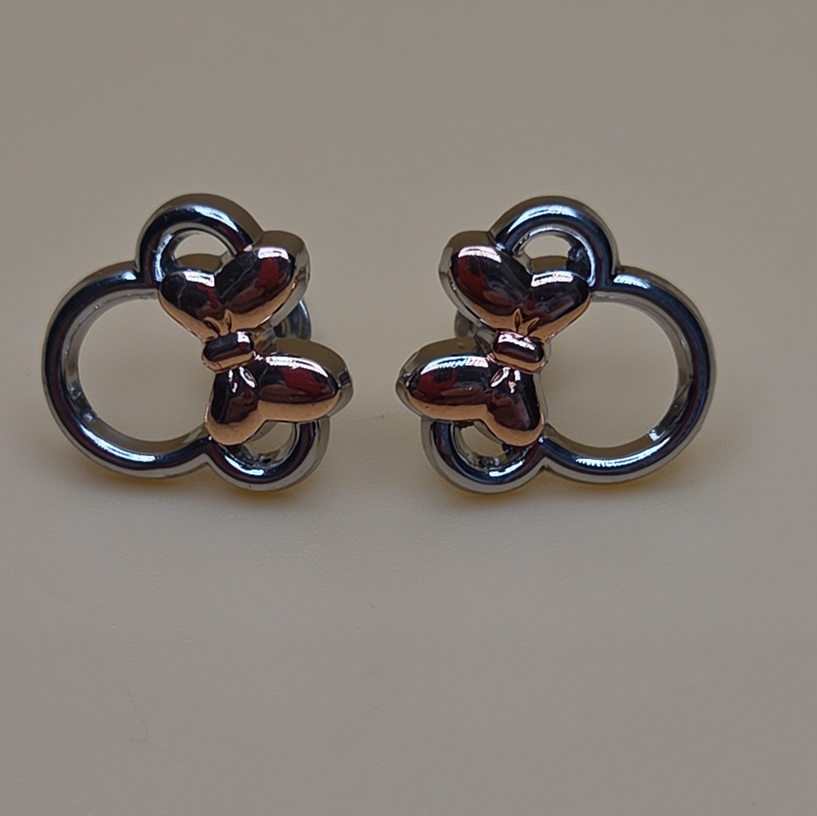 Silver and Rose Tone Ear And Bow Stud Earrings with Butterfly Back Closure