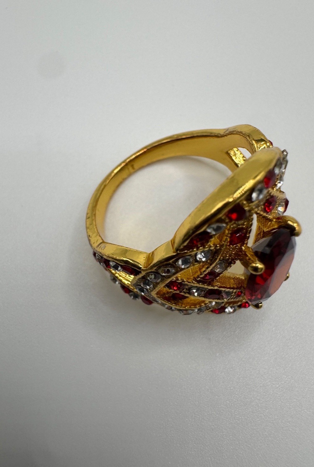 Gold tone statement ring bundle with one central stone and ornate accent stones
