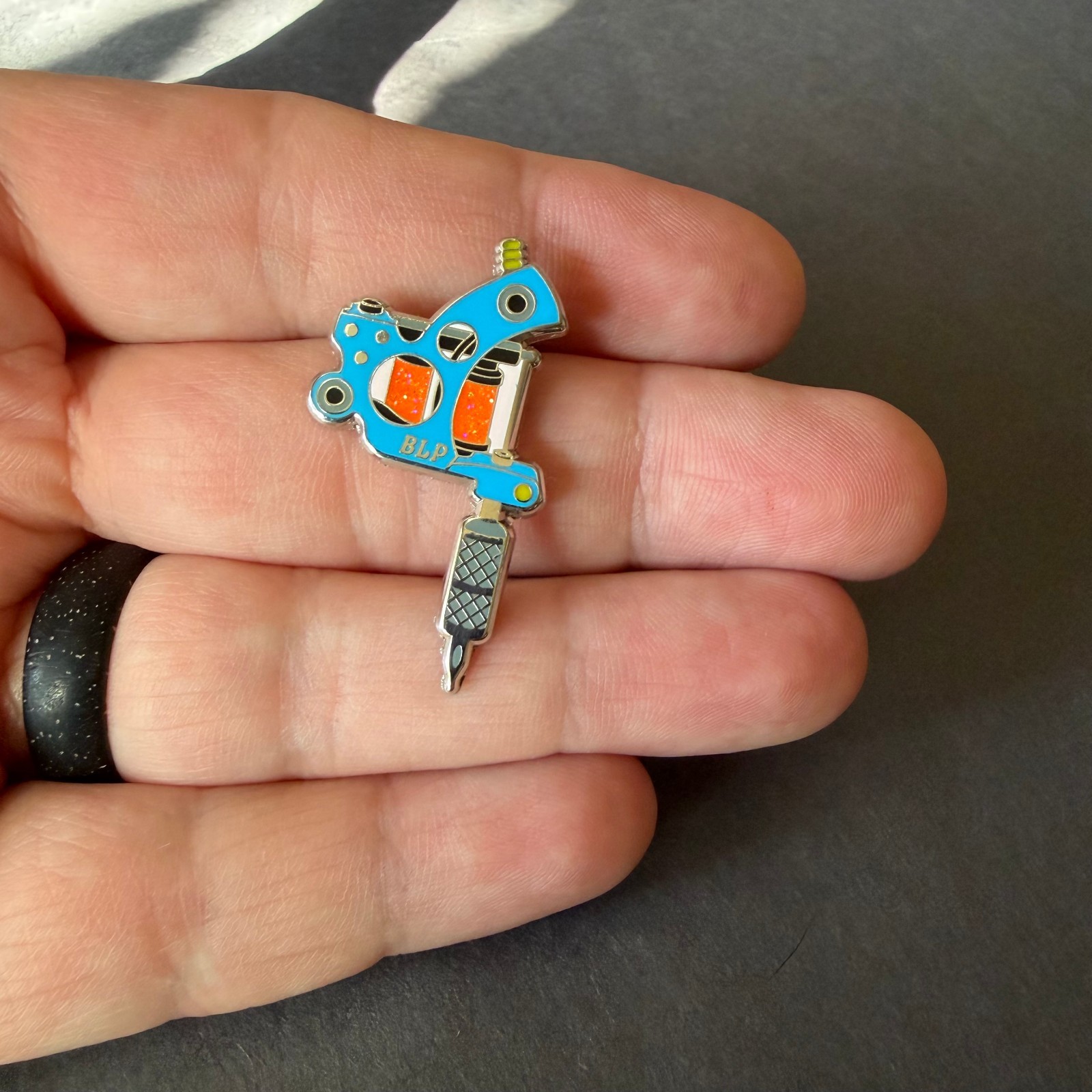Tattoo Machine Enamel Pin – Blue with Orange Glitter