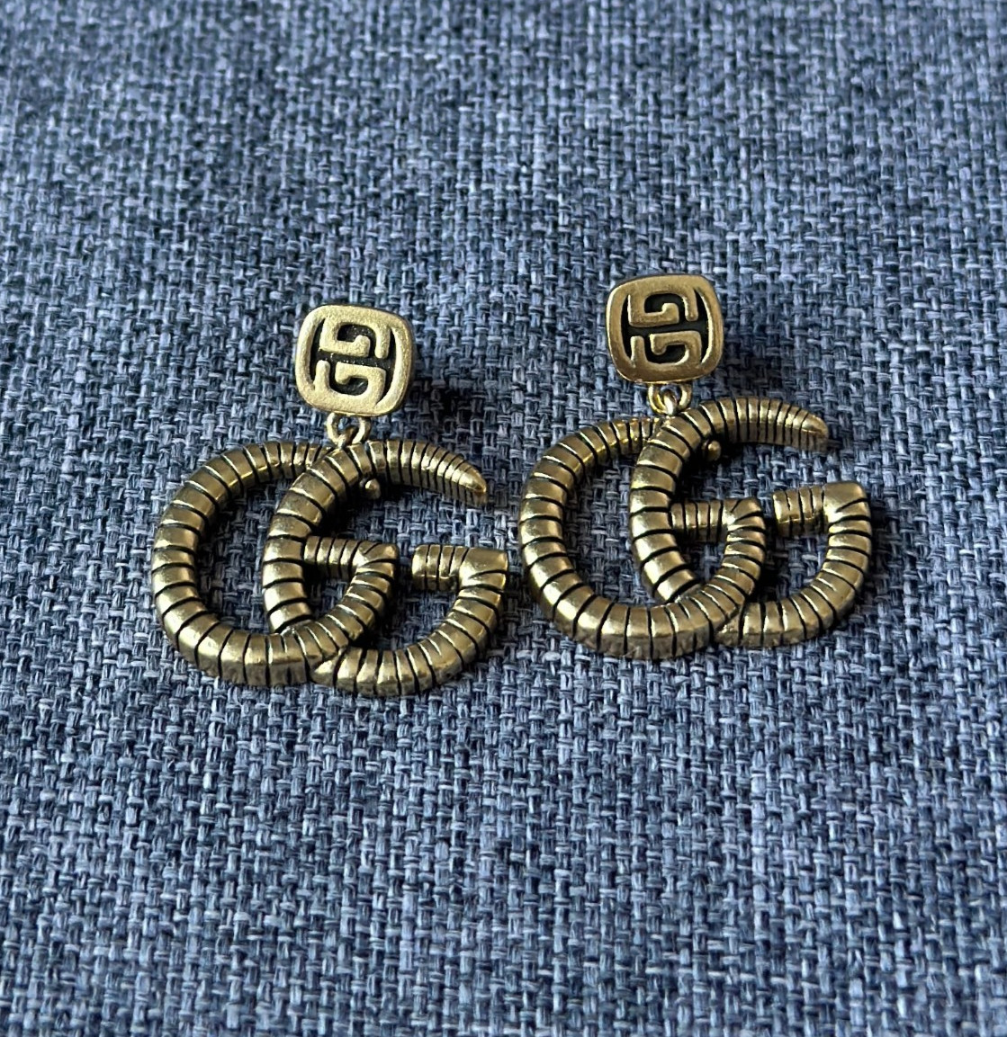 Gucci Interlocking GG Dangle Drop Earrings Gold Tone Textured Logo Statement