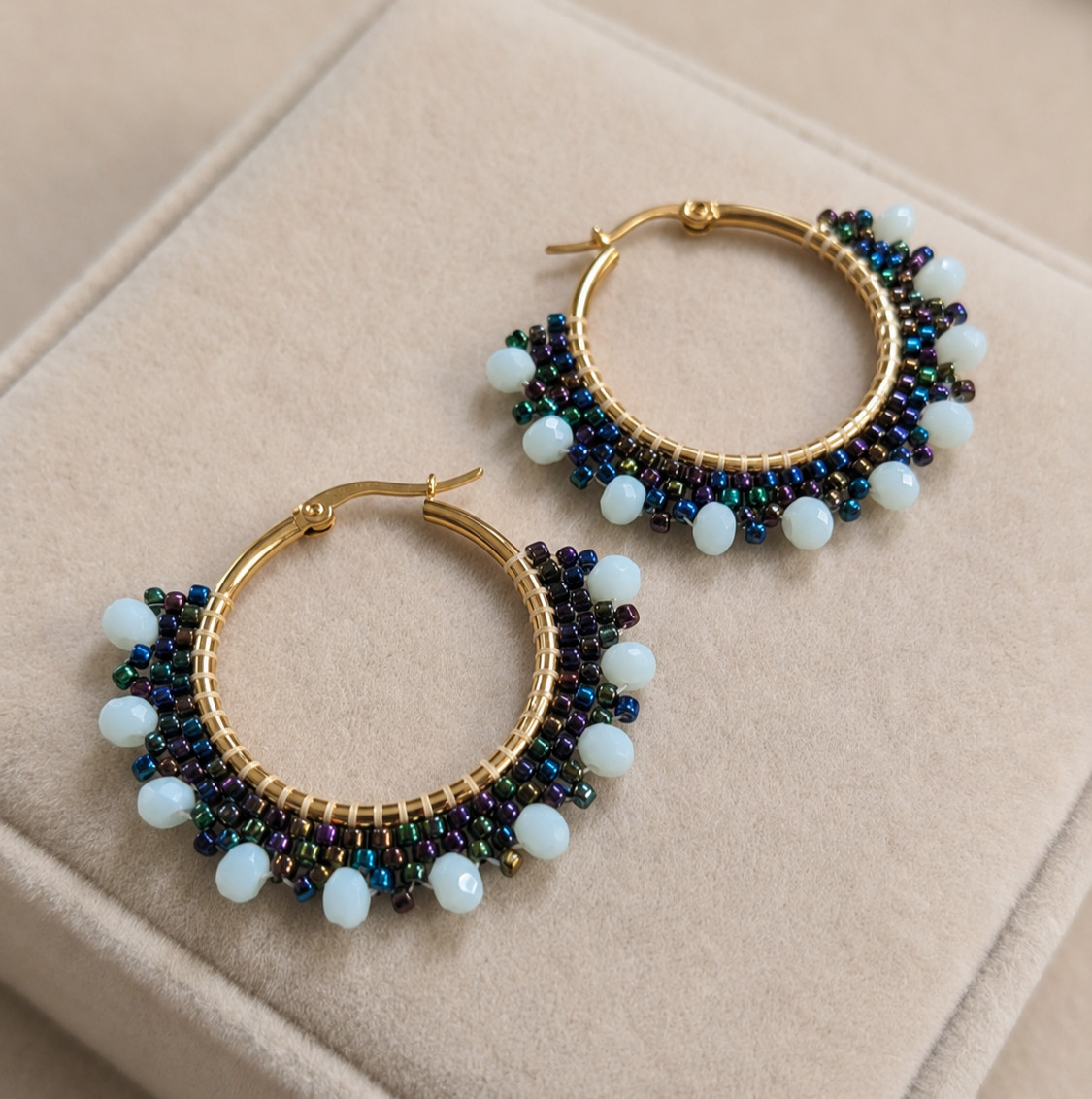 Hoop circle earrings with black peacock seed beads and blue beads