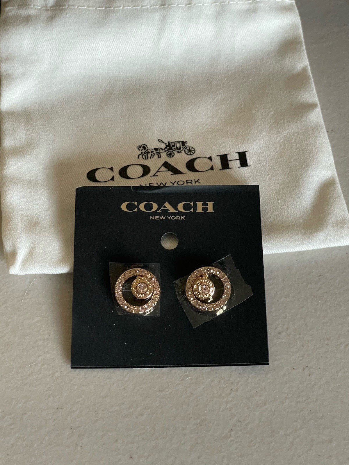 COACH YELLOW GOLD TONE PAVE OPEN HALO STUD EARRINGS