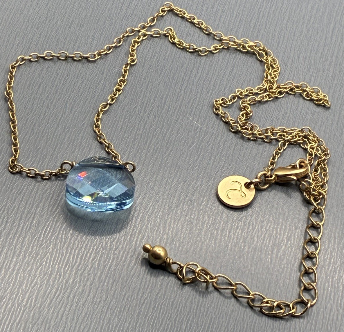 Touchstone Light Sapphire, Briolette, Swarovski Crystal Gold Tone Necklace