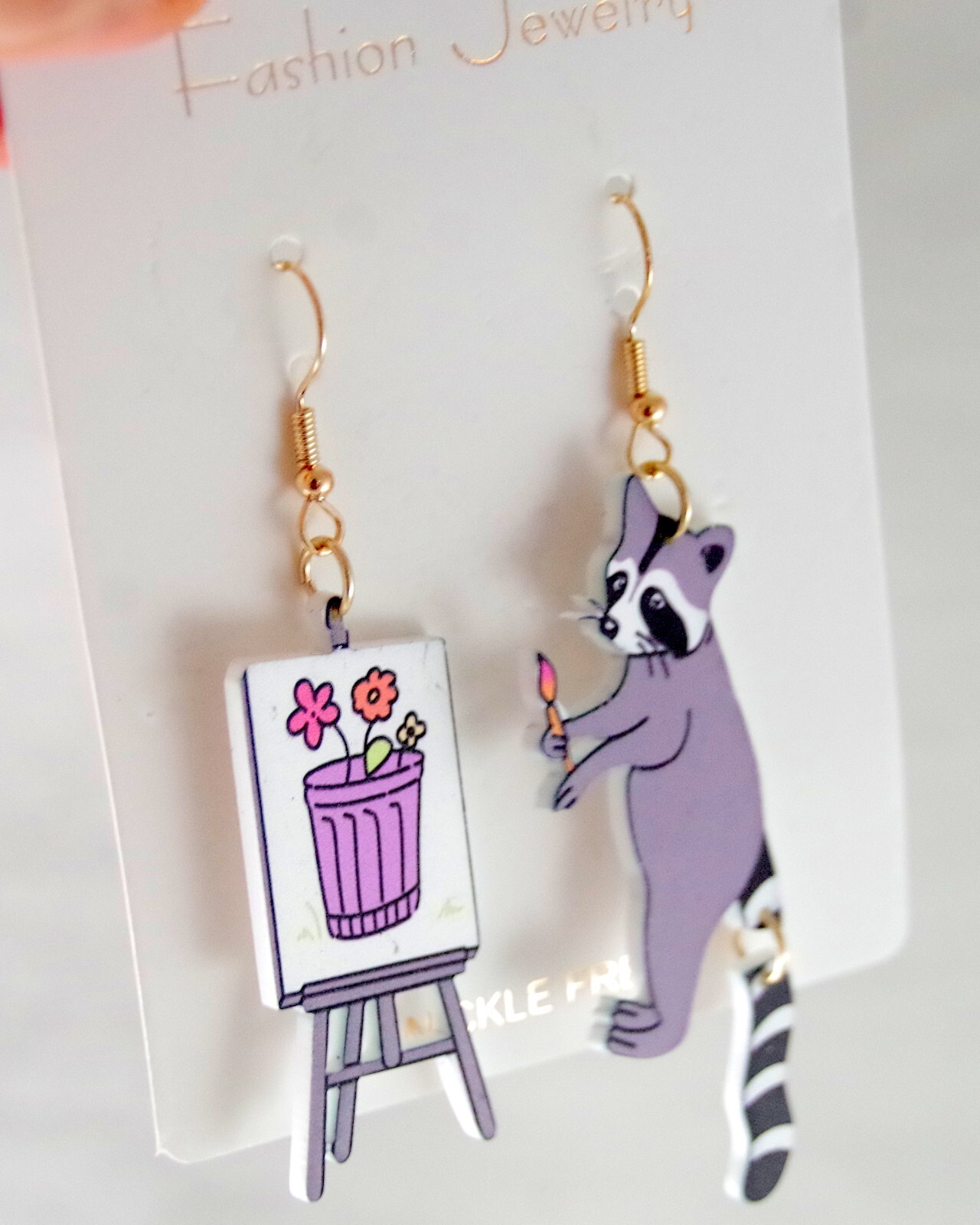 ASYMMETRICAL RACOON ARTIST PAINTING FLOWERS IN GARBAGE CAN ACRYLIC DROP EARRINGS