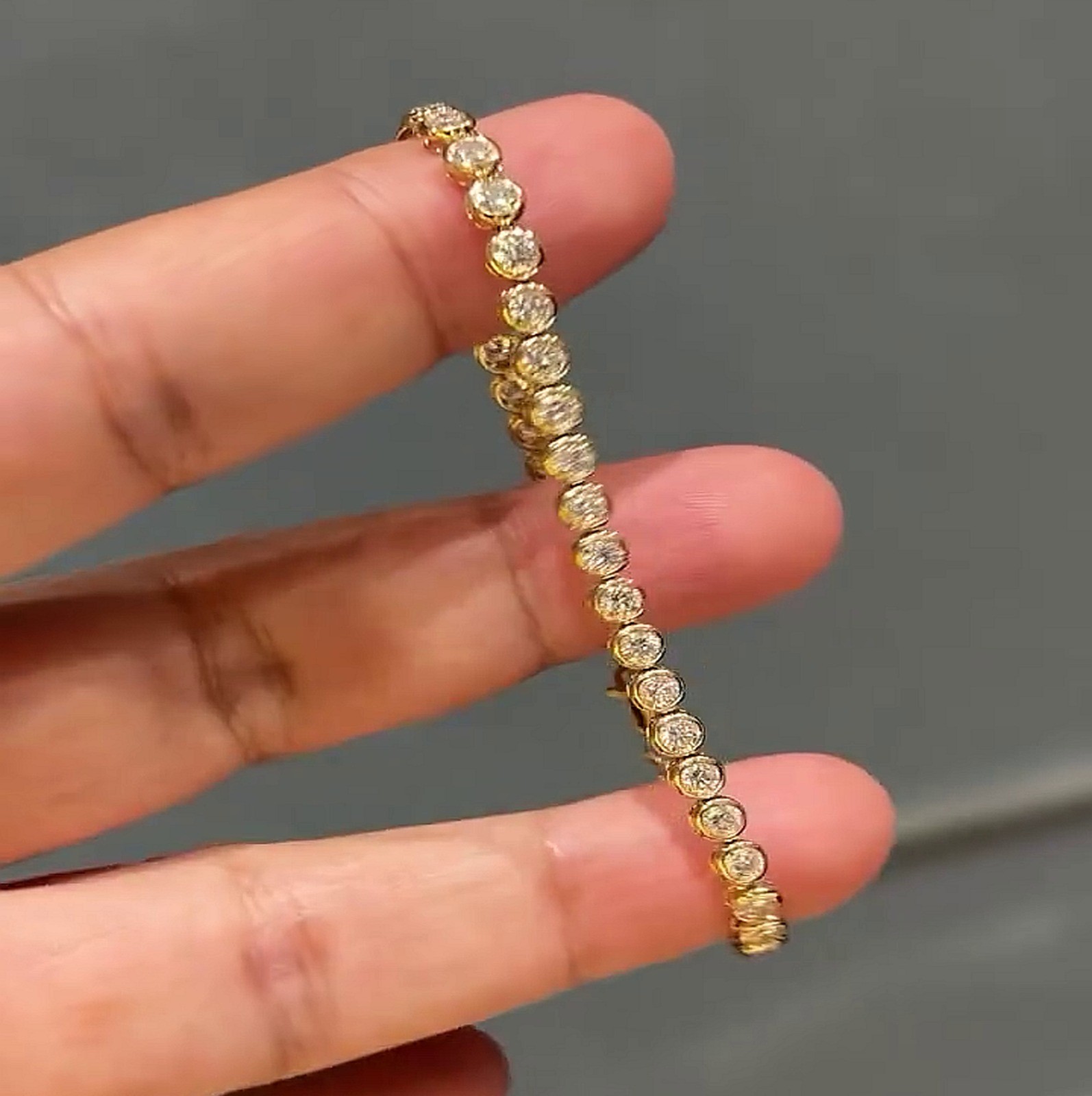 7.0ctw Round Cut Moissanite Bezel Set Tennis Bracelet In 14K Yellow Gold Plated