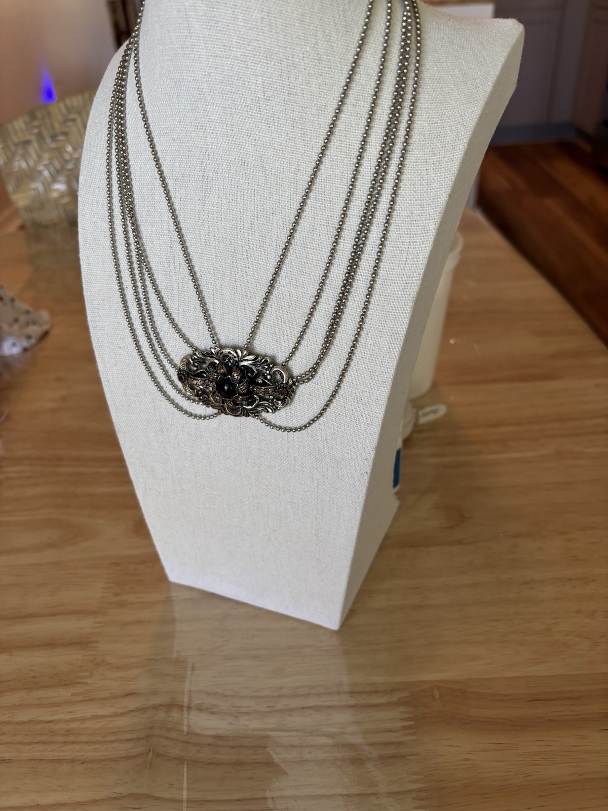 Goldtone Around Black Stone Piece , Chain Is Shades Of Silver. Small Stone Red