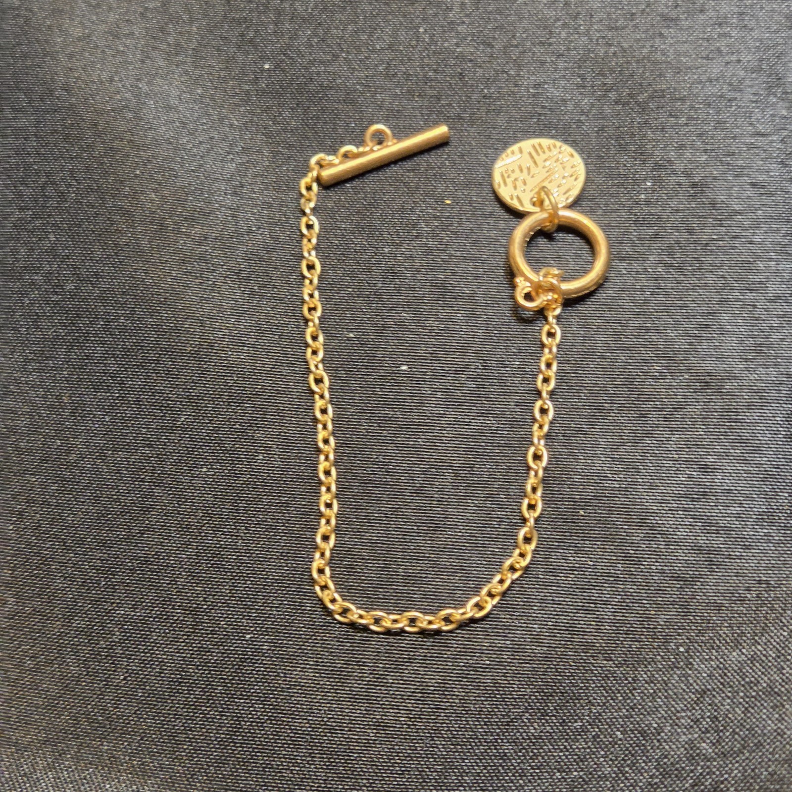 Elegant Gold-tone Bracelet With Toggle Clasp And Engraved Charm Accent