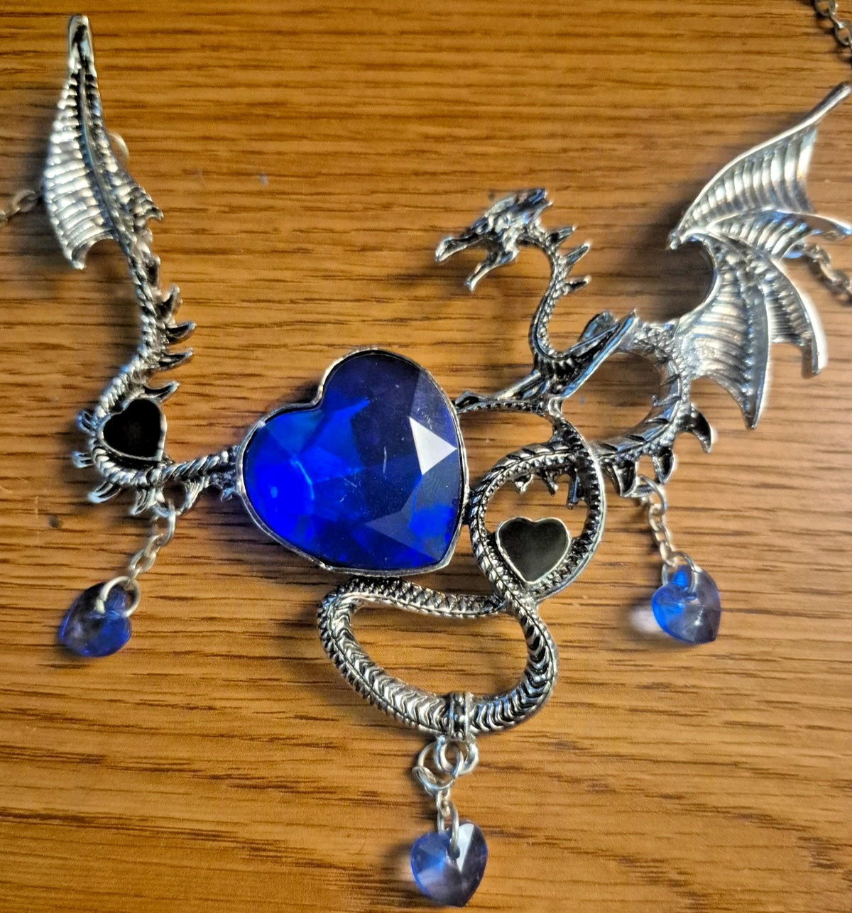 **SILVER TONED MYTHICAL DRAGON NECKLACE WITH BLUE CRYSTAL LIKE GEMS**