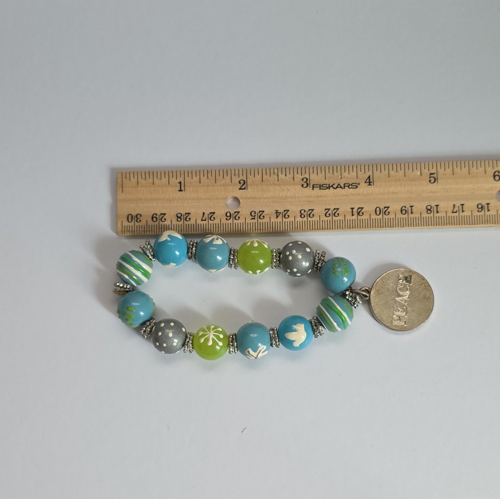 Vintage Angela Moore hand-painted beaded bracelet features blue, green, & gray