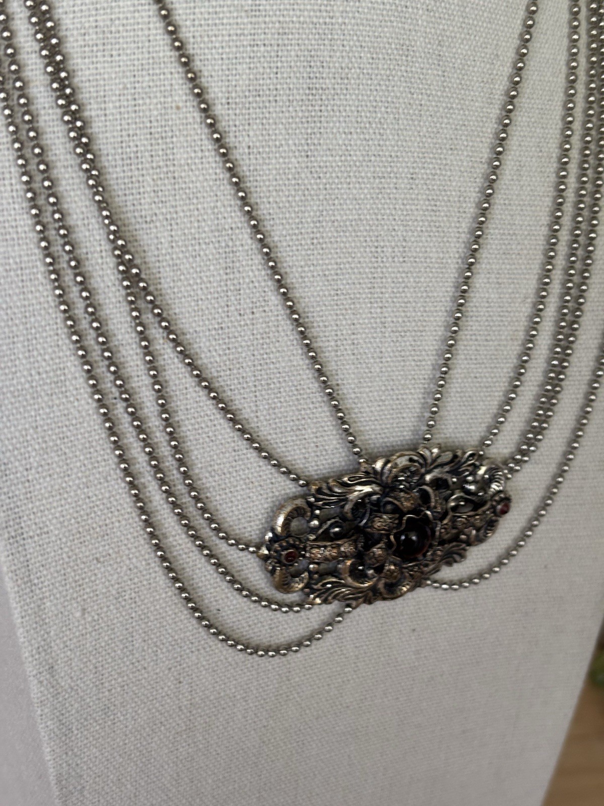 Goldtone Around Black Stone Piece , Chain Is Shades Of Silver. Small Stone Red