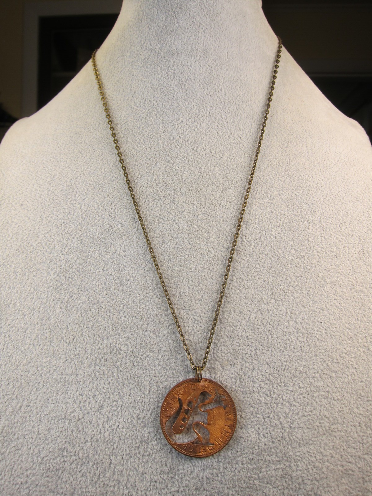 Cute 1967 British penny coin cutout necklace Godzilla grabbing airplane!