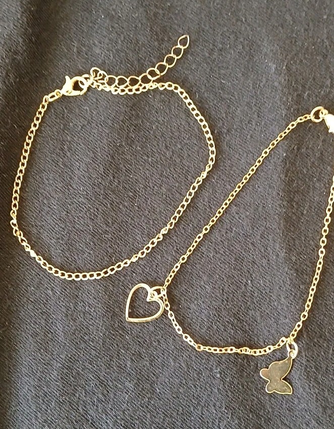 A Set of 2 Anklets, 1 gold tone Chain and 1 with 2 charms on a gold tone chain