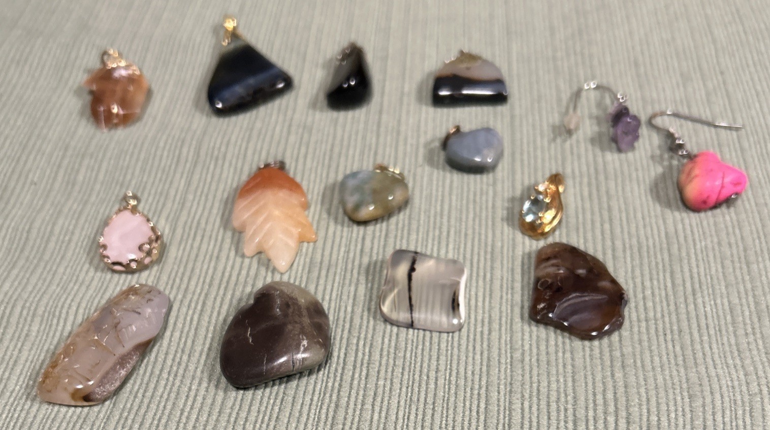 collection of 15 polished gemstone pendants and stones