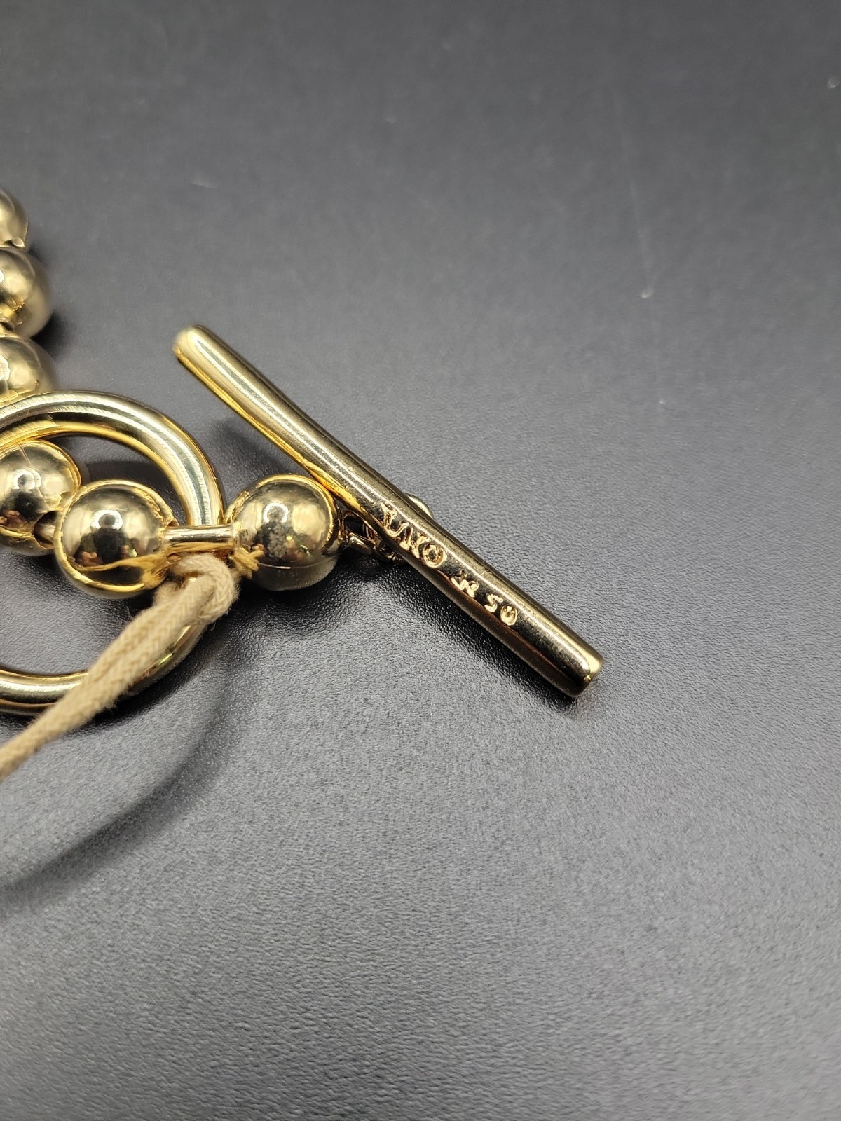 Uno De 50 Gold Tone Bead Ball On-Off Toggle Bar Bracelet Size M