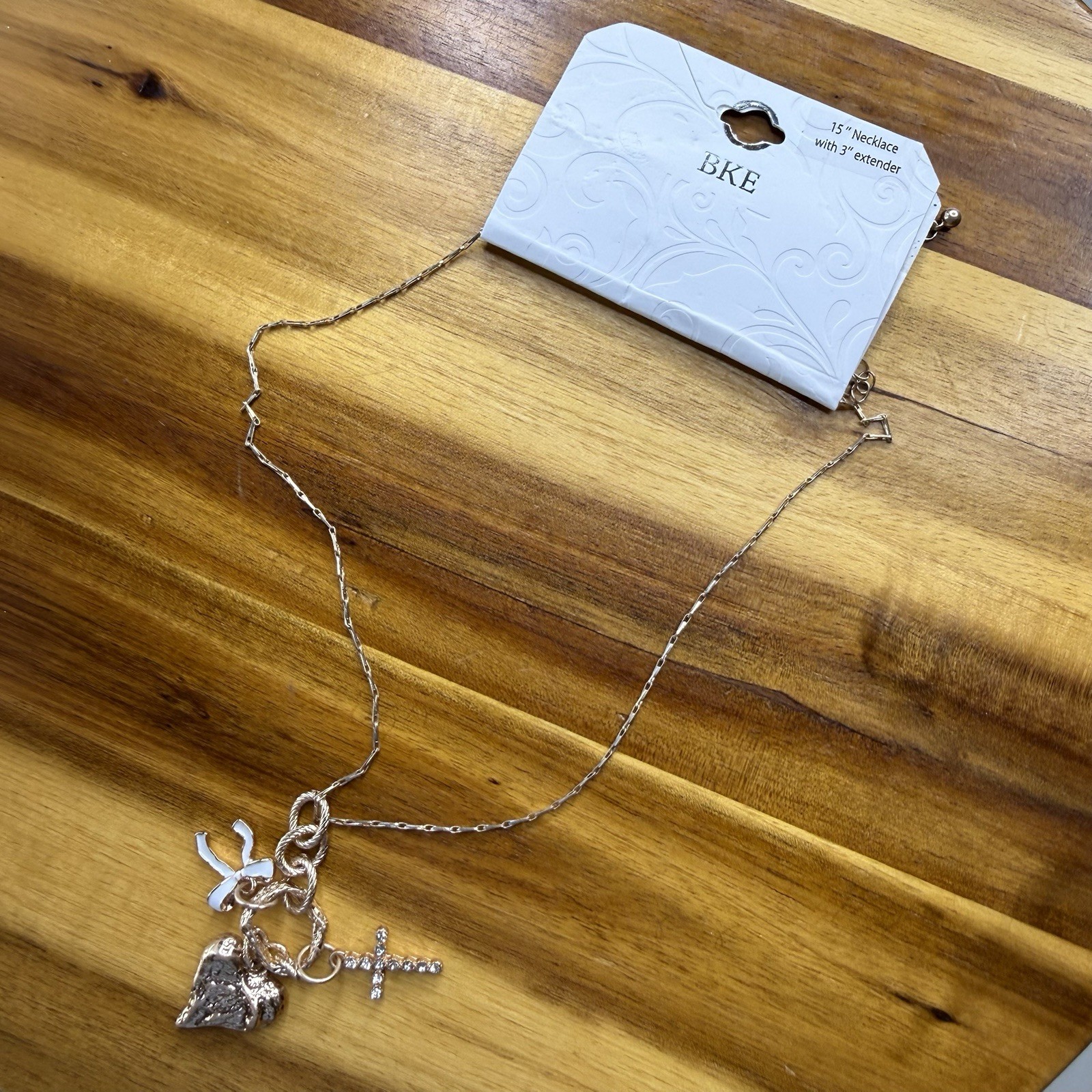 BKE Gold Tone Multi Charm Pendant Necklace Heart Cross Bow 15” + 3” Extender