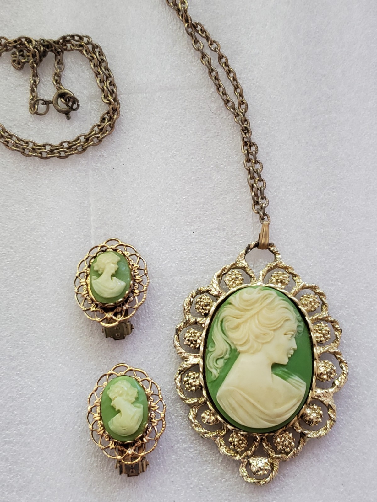 Gold-tone metal green/ivory plastic/resin cameo pendant & clip on earrings