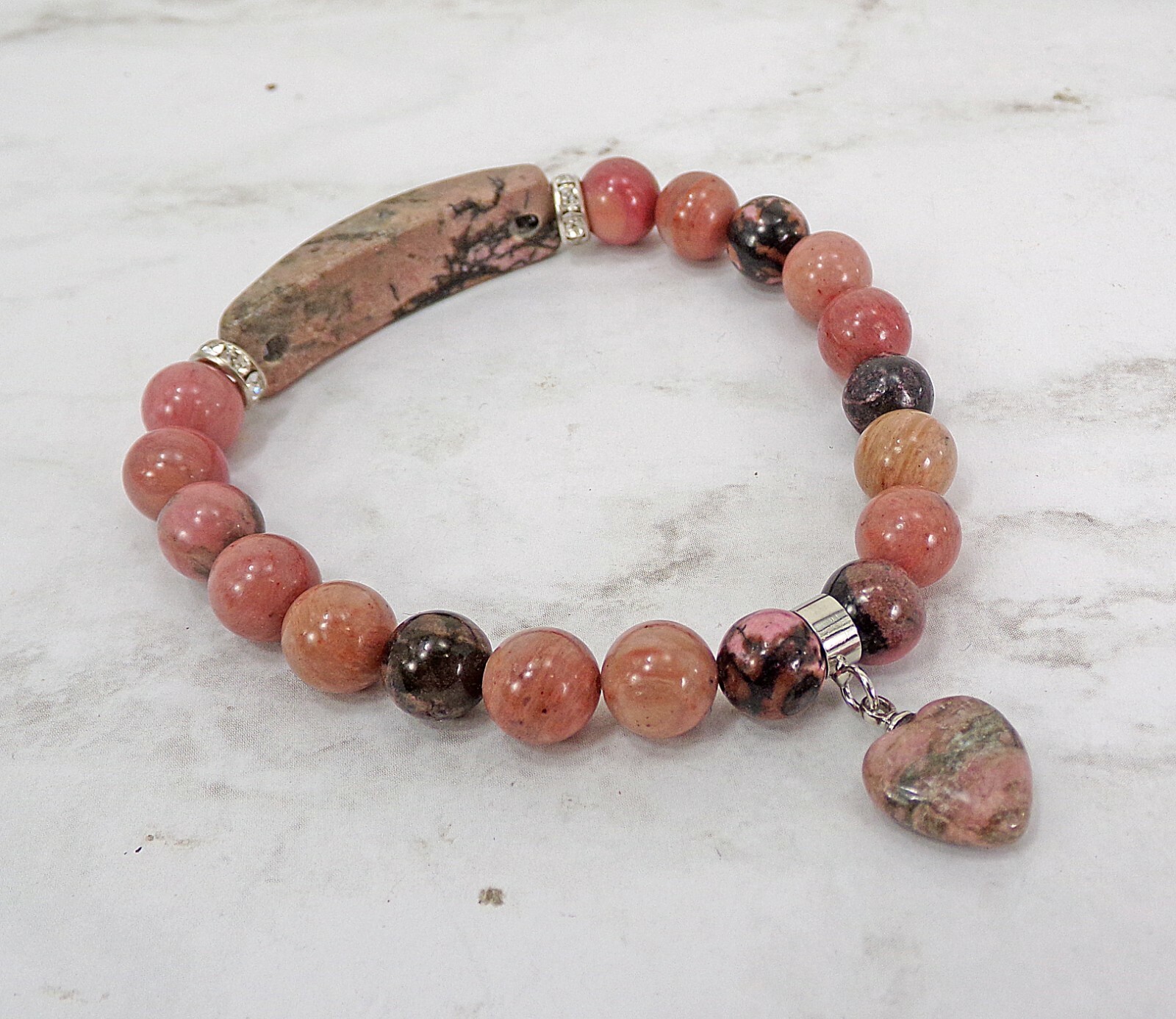 Pink heart charm bracelet made in rhodonite stone beads and crystal spacer beads