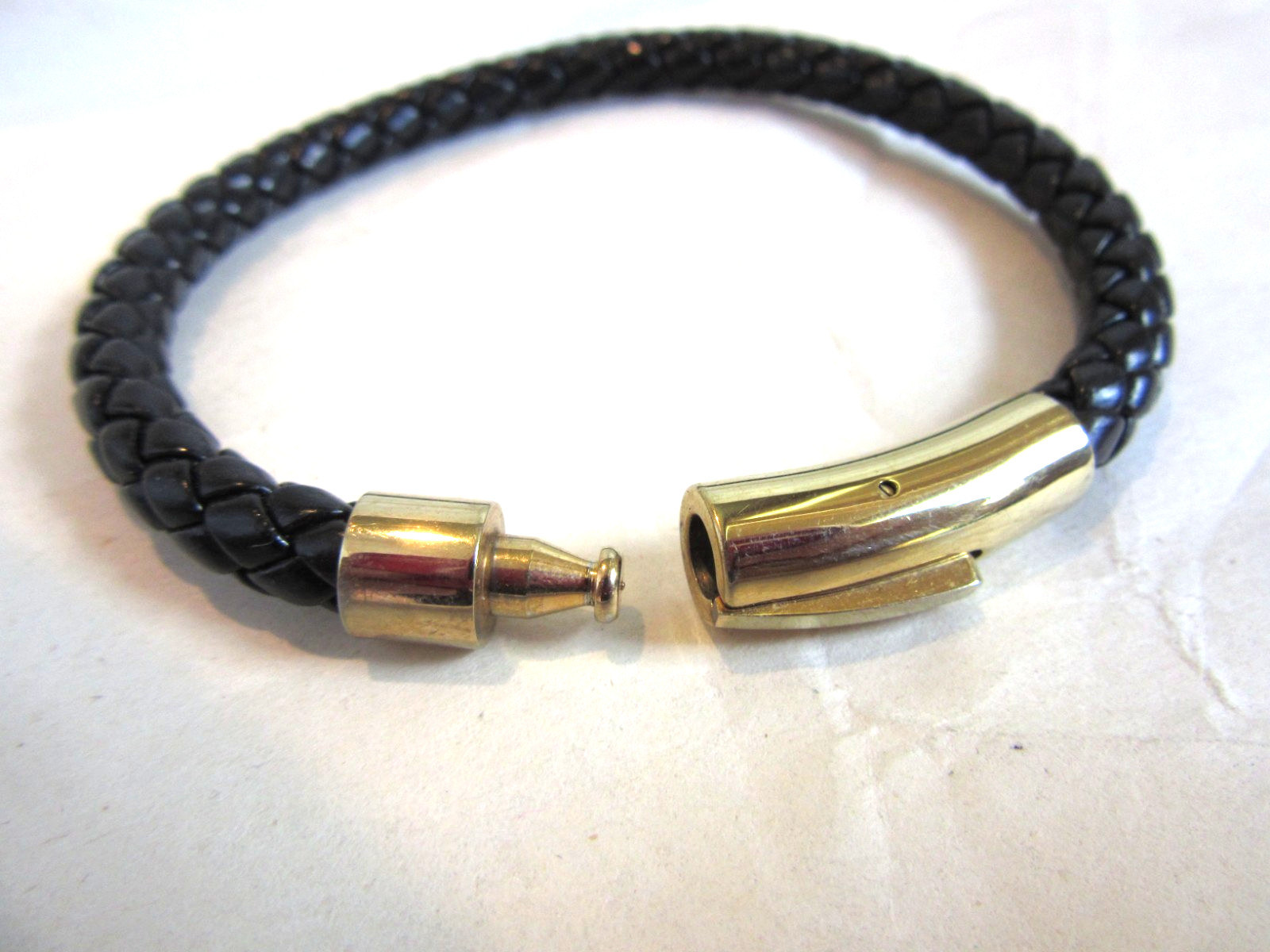 Black braided faux leather bracelet with a push lock clasp