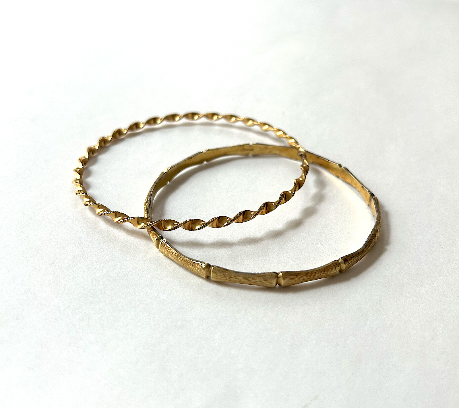 2 vintage gold-tone bangle bracelets: Krementz bamboo-style, unbranded twist