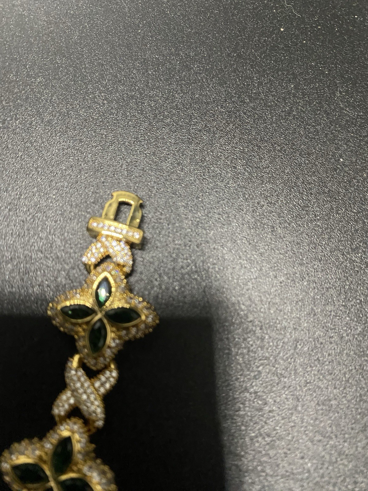 8in 15mm 10k gold plated clover bracelet with emerald clovers.