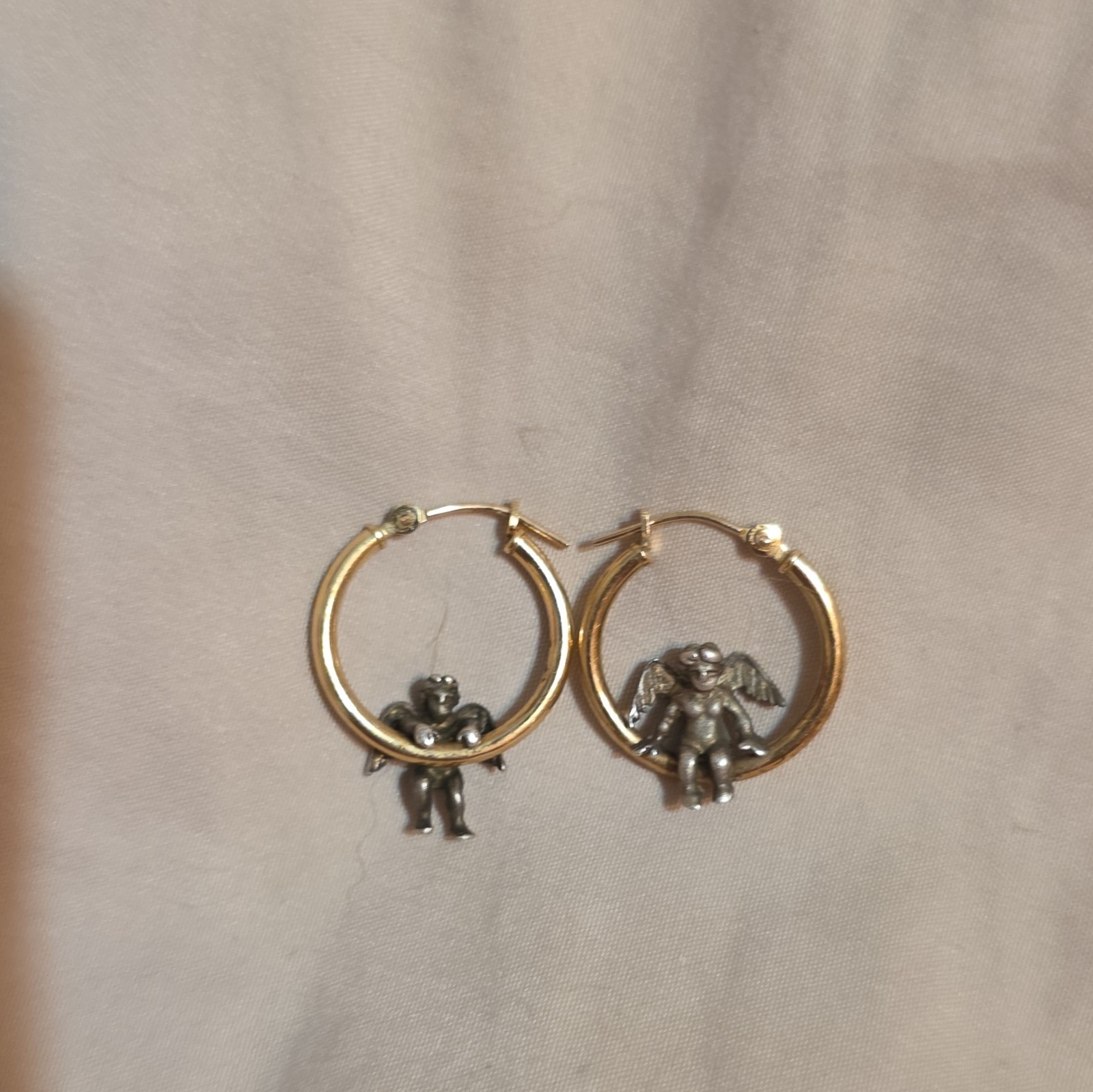 These earrings are vintage Jacmel JCM 14K yellow gold hoops with sterling angels