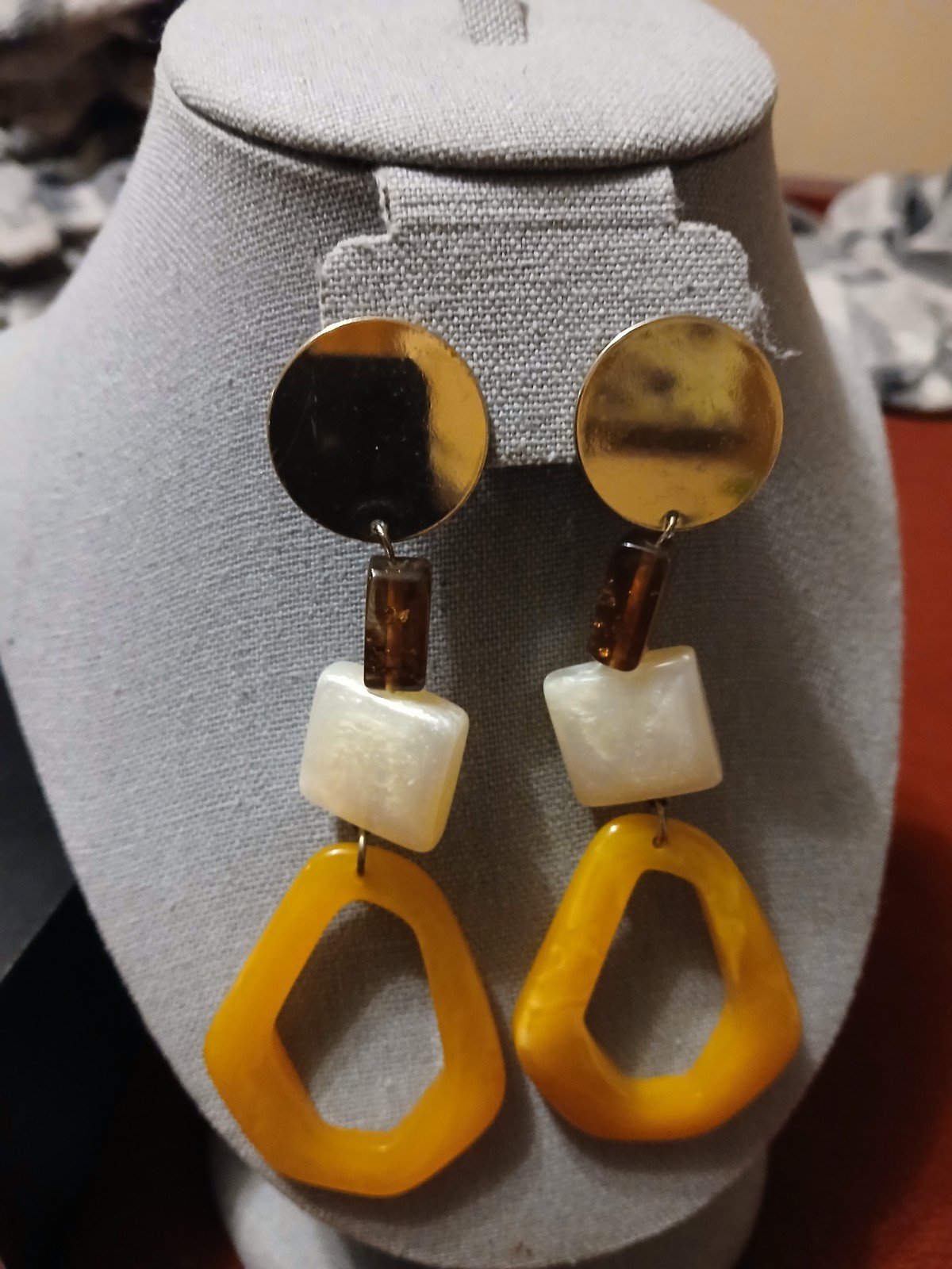 H&M gold-toned long earrings feature a striking geometric design with yellow…