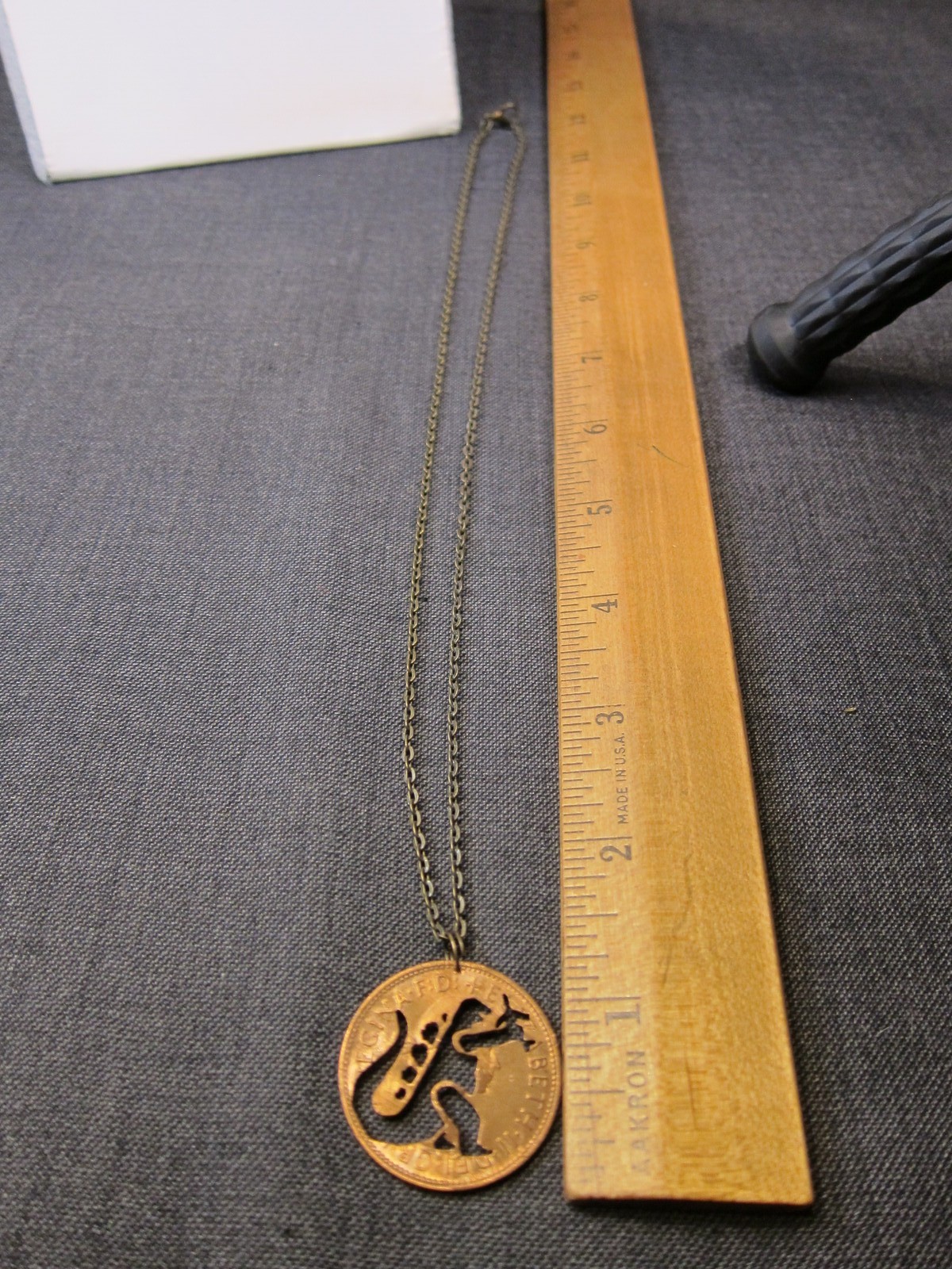 Cute 1967 British penny coin cutout necklace Godzilla grabbing airplane!