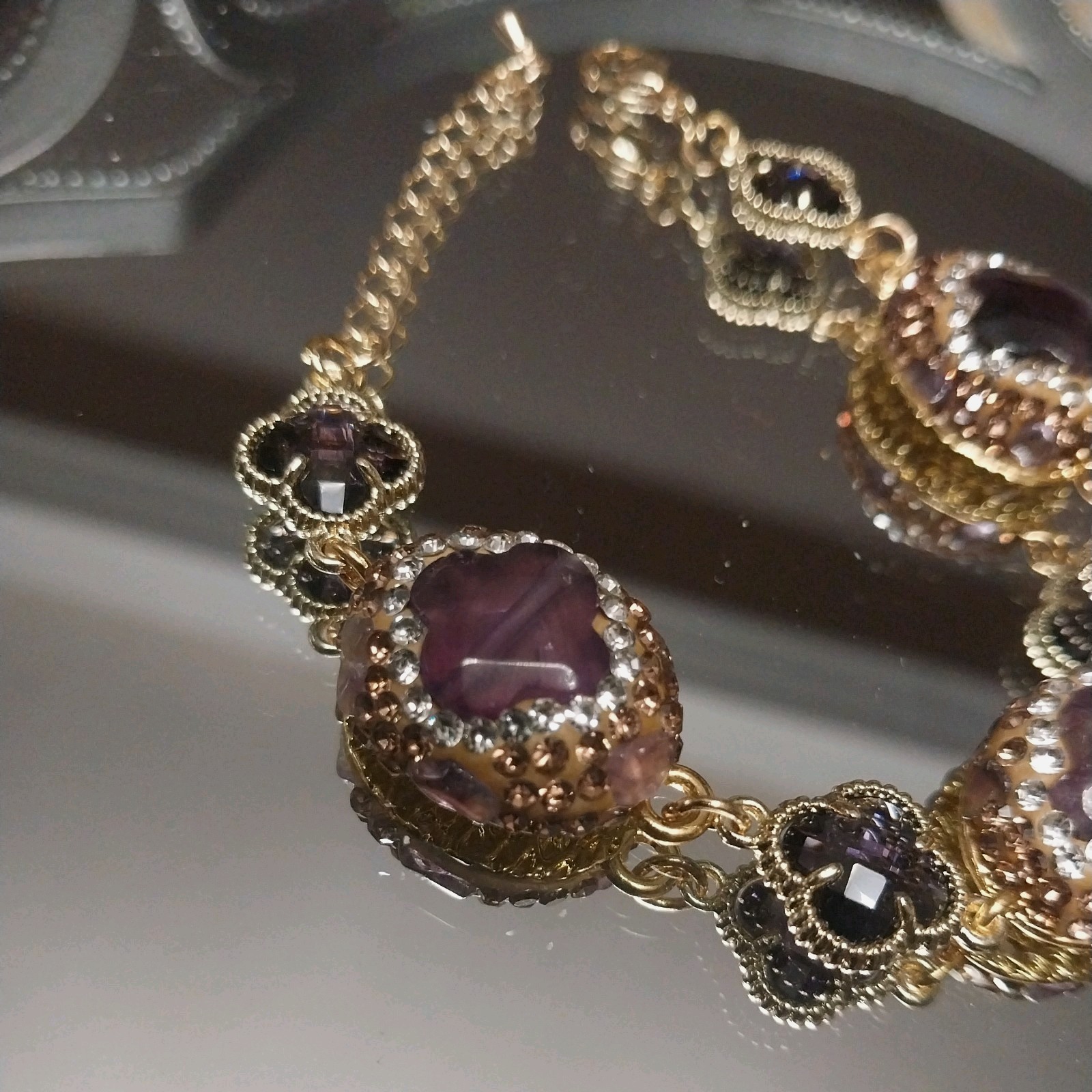 Gold Plated bracelet with purple amethysts and sparkling clover-shaped crystals.