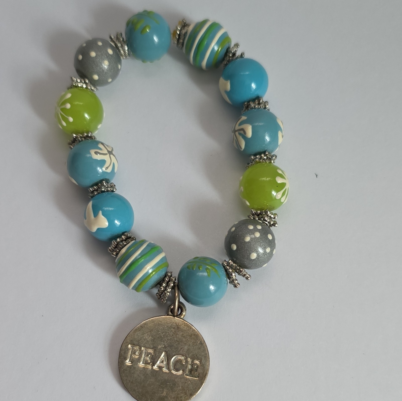 Vintage Angela Moore hand-painted beaded bracelet features blue, green, & gray