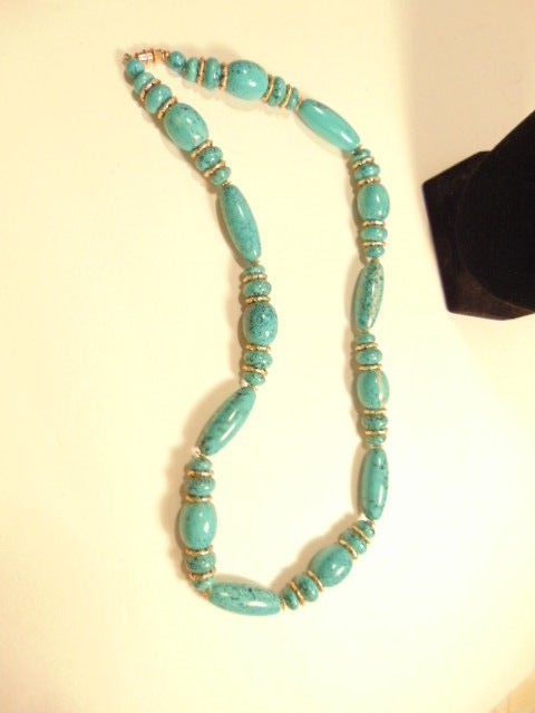 greenish blue beaded necklace with gold colored spacers – about 11 inches length