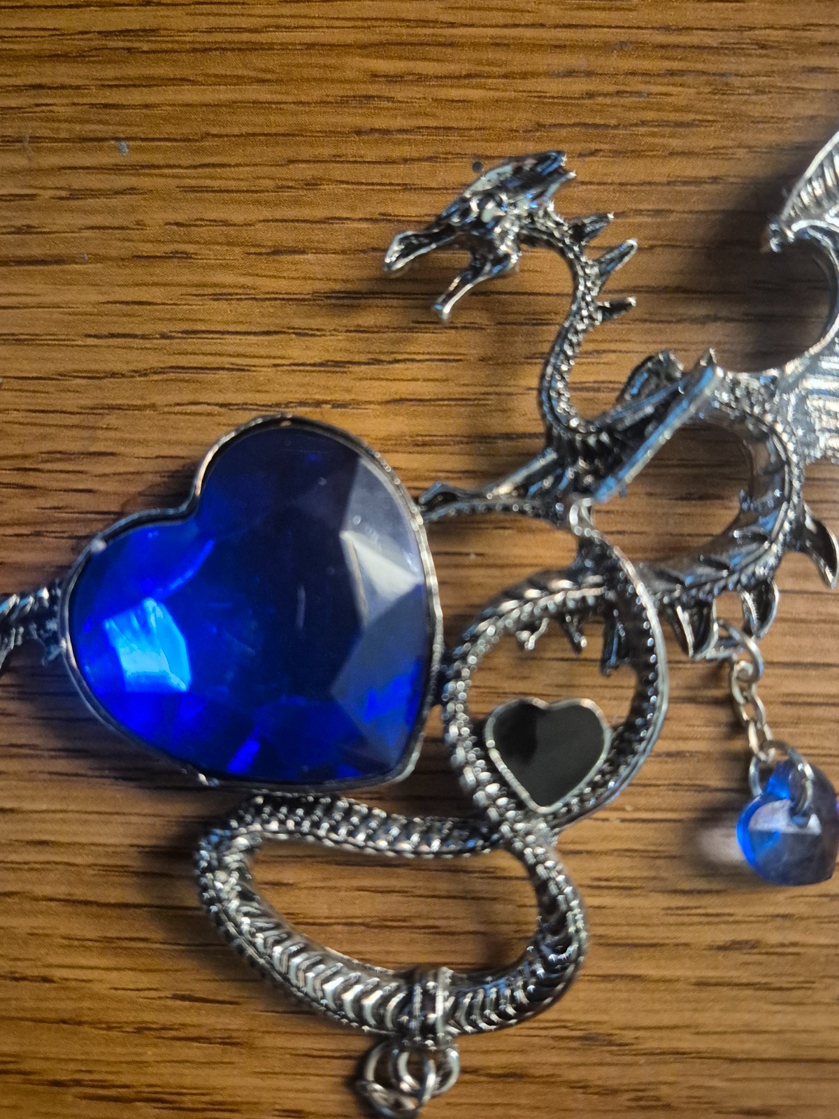 **SILVER TONED MYTHICAL DRAGON NECKLACE WITH BLUE CRYSTAL LIKE GEMS**