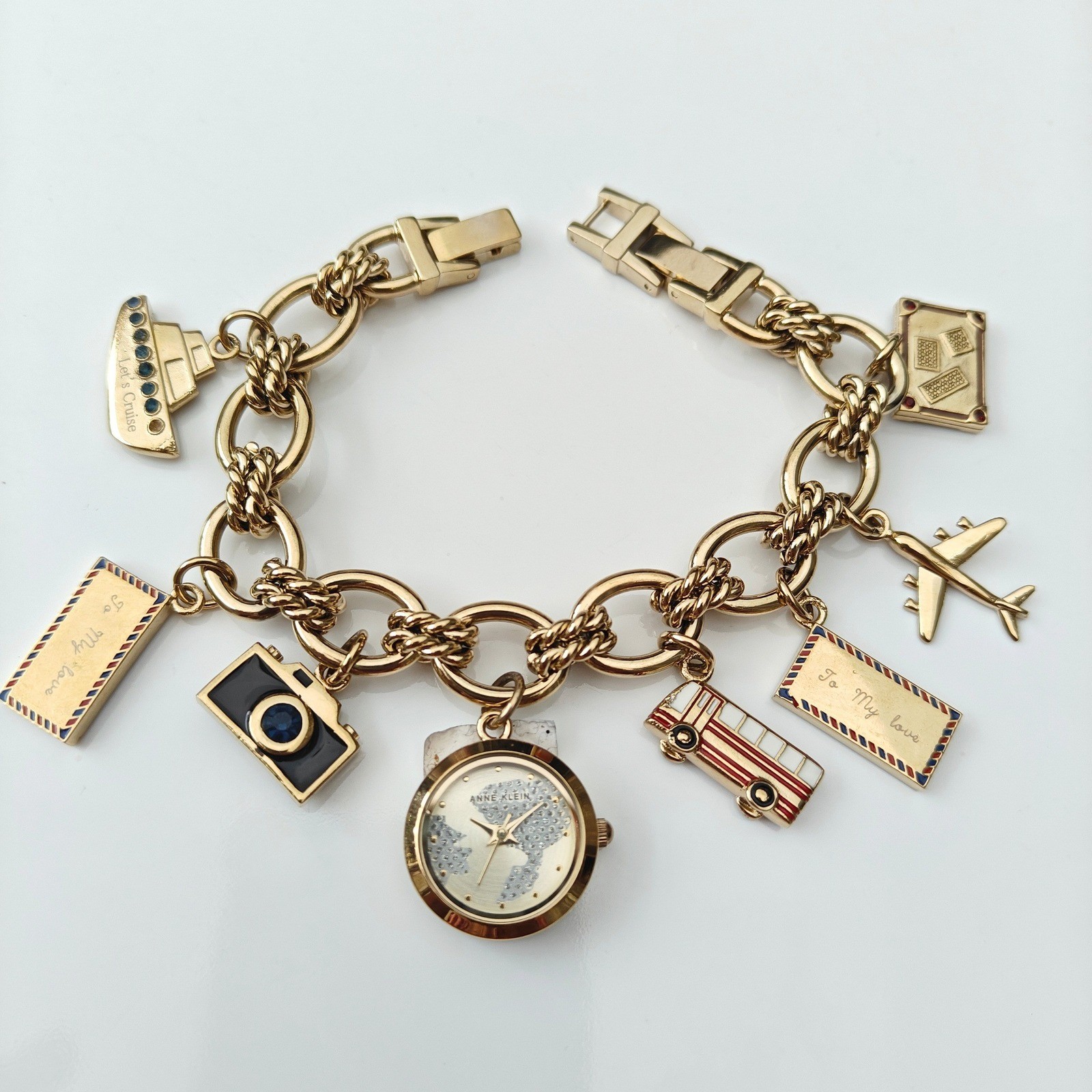 Anne Klein Womens Gold Tone Travel Charm Bracelet Watch World Map Airplane Bus