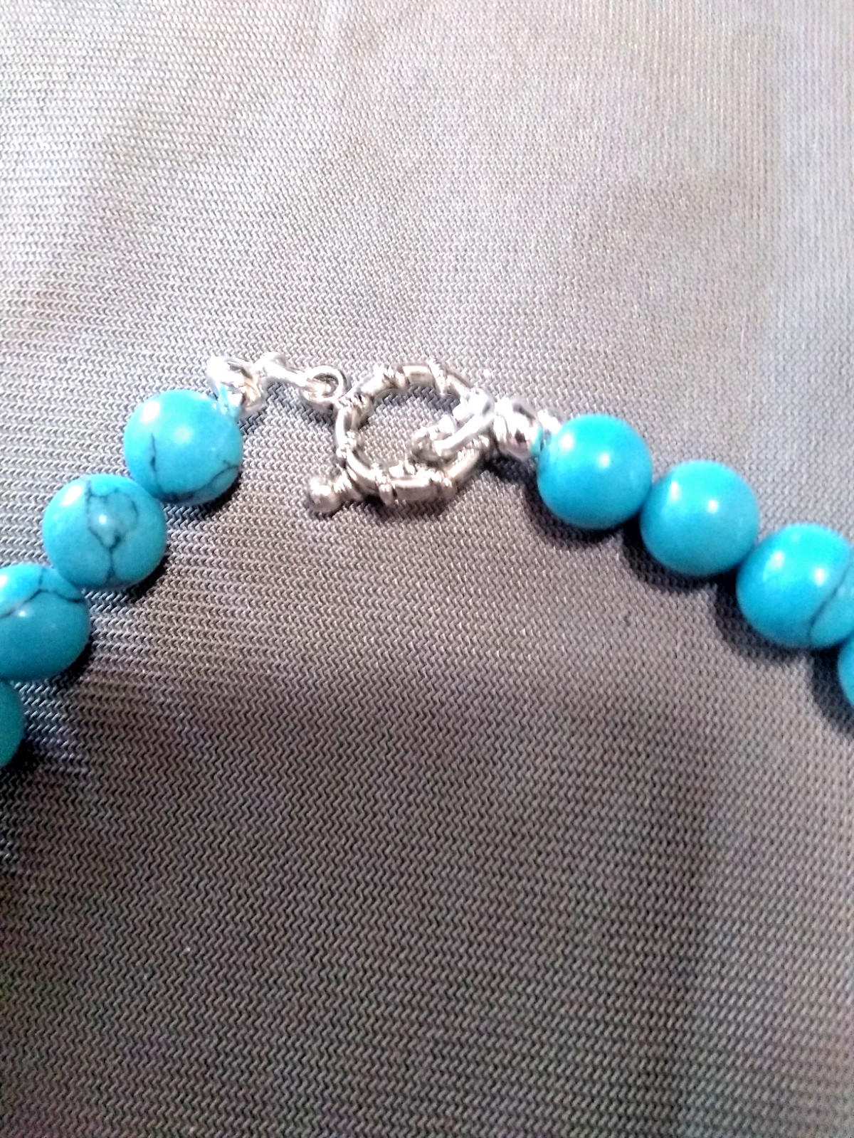 20″ necklace made of Turquenite beads and blue silver spacers with toggle clasp