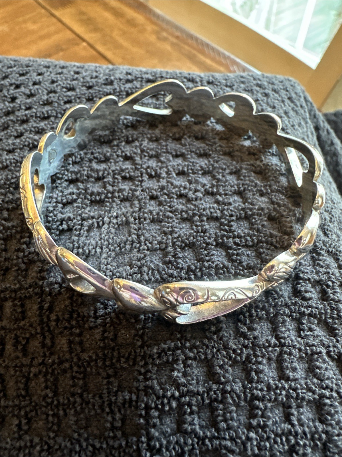 Brighton Open Heart bangle bracelet featuring silver-plated pierced hearts.