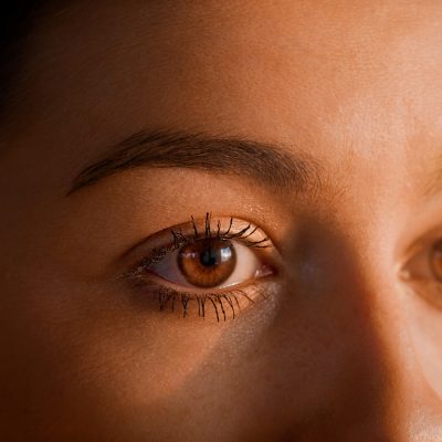 Female human eye details. Studio shot of woman putting on make up